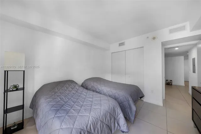 a bedroom with a bed and a mirror