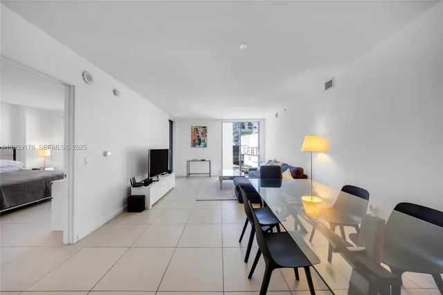 a view of a dining room with furniture and a window