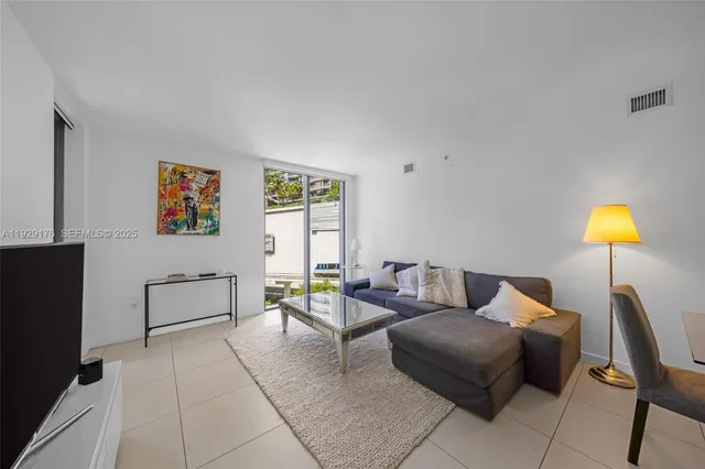 a living room with furniture and lamp