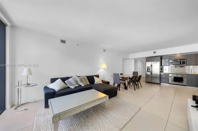a living room with furniture a dining table and a stove top oven