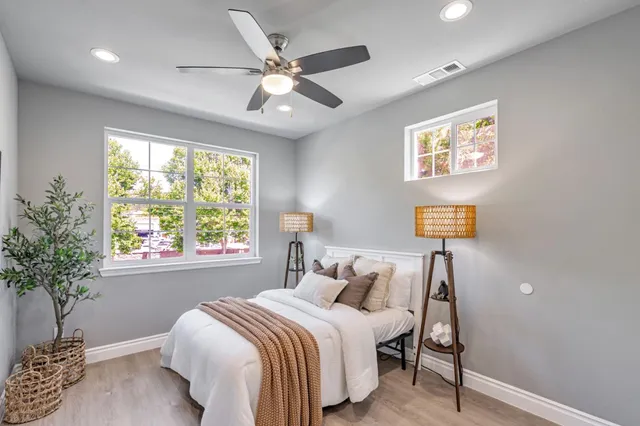 a bedroom with a bed and a potted plant