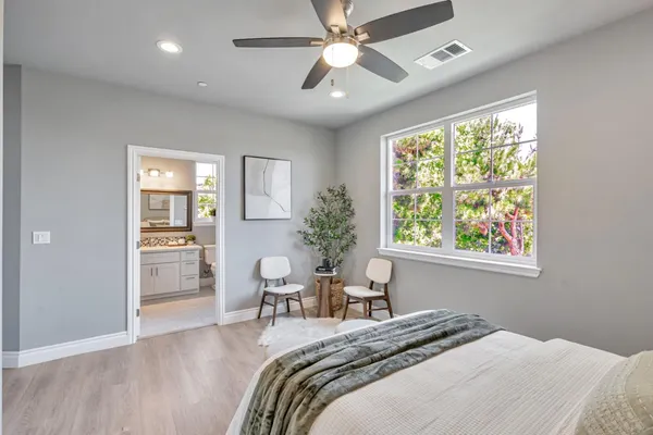 a bedroom with a bed and a chair