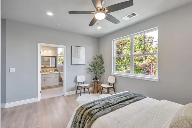 a bedroom with a bed and a chair