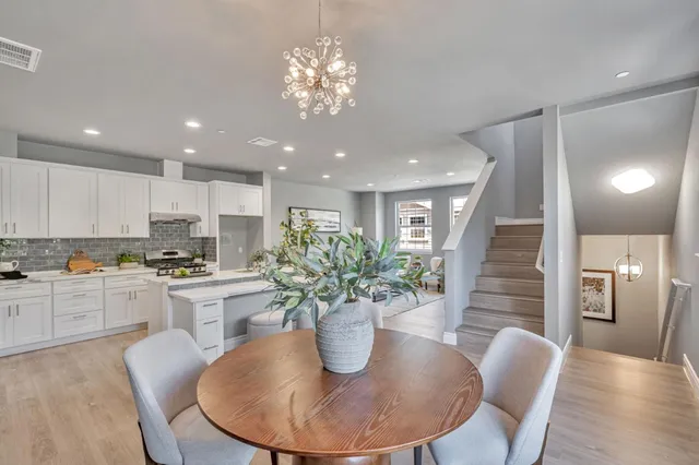 a kitchen with a table and chairs