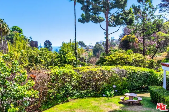 a view of a patio with a table and chairs