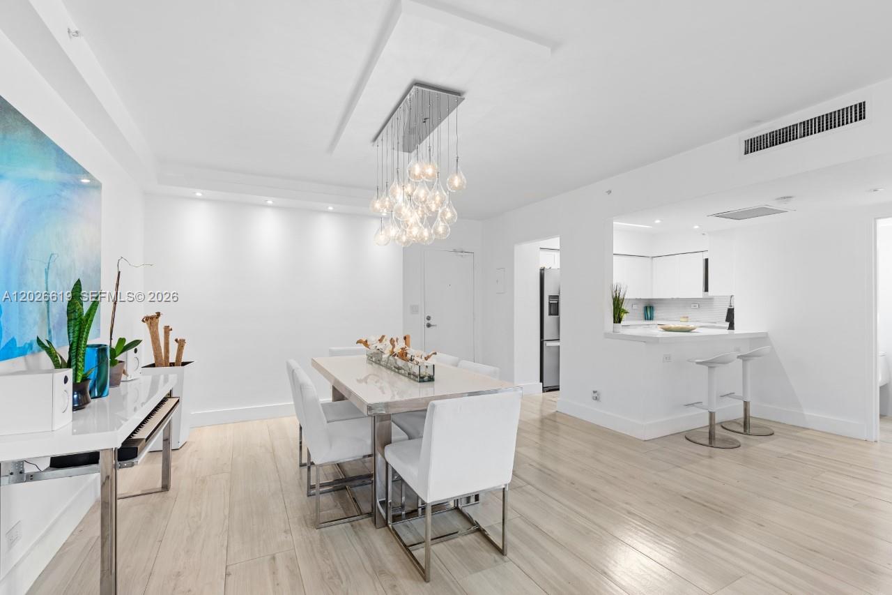 1500 Bay Road, Unit 1268S Miami Beach, FL 33139 - Photo 9 of 31 a view of a dining room with furniture and wooden floor