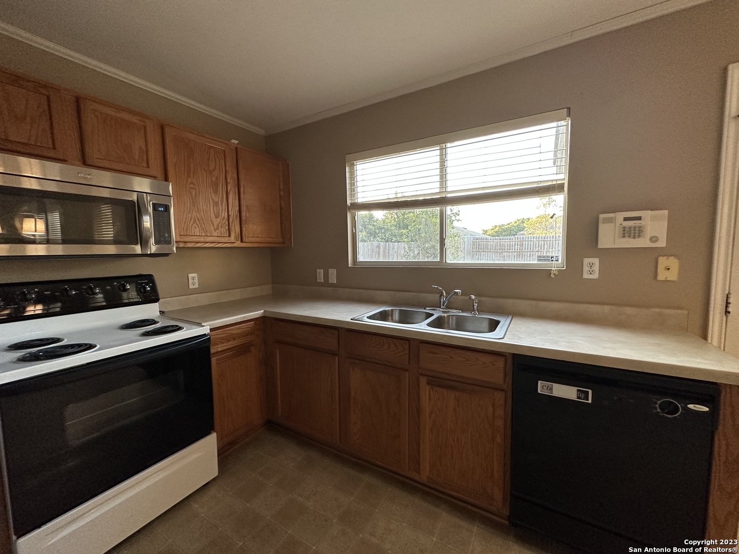 8019 Rio NIEBLA San Antonio, TX 78249 - Photo 1 of 16 a kitchen with a sink stove and microwave