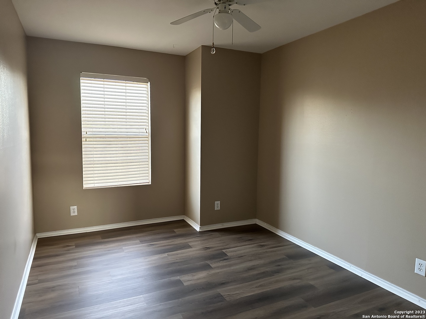 8019 Rio NIEBLA San Antonio, TX 78249 - Photo 14 of 16 an empty room with wooden floor and windows