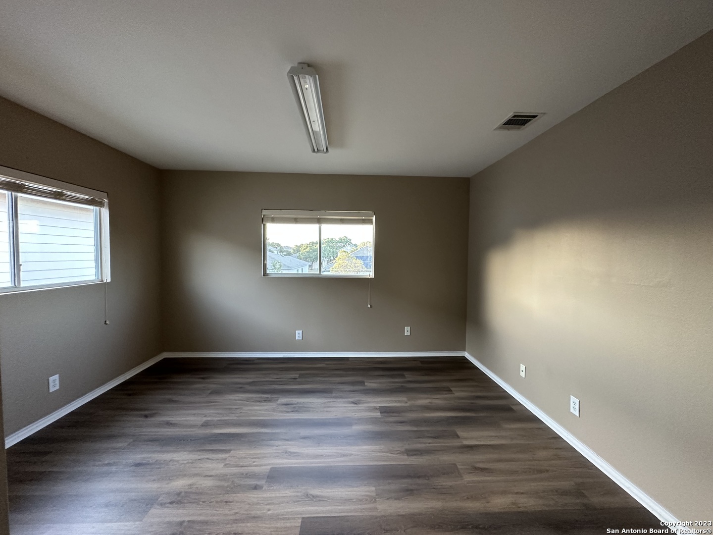 8019 Rio NIEBLA San Antonio, TX 78249 - Photo 16 of 16 an empty room with wooden floor and windows