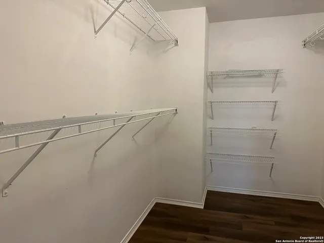a view of walk in closet with clothes