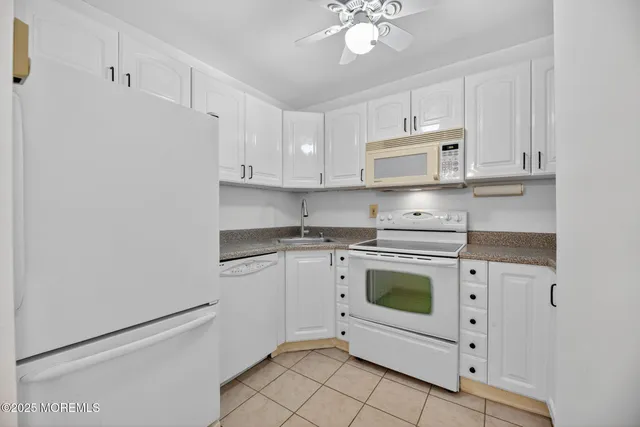 a view of a room with a kitchen