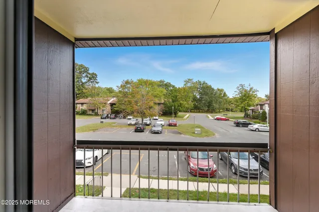 a view of hallway with a large mirror and shower