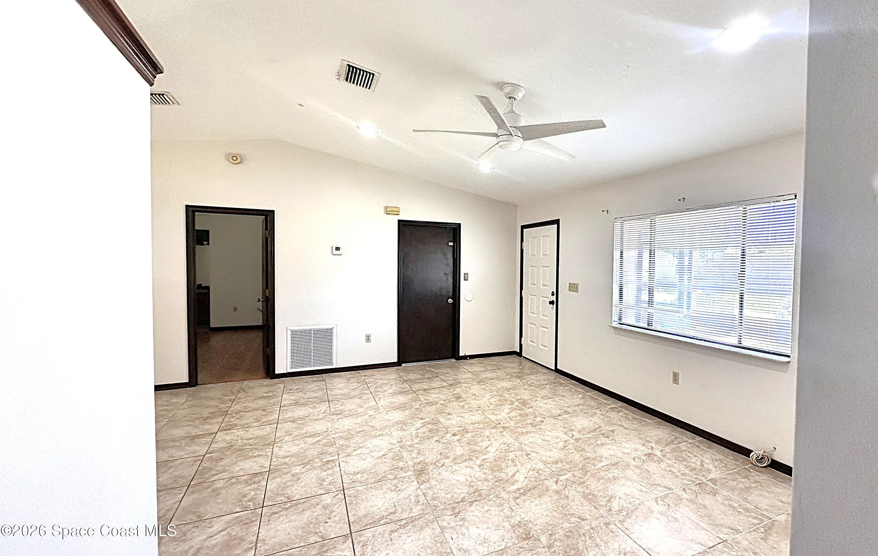 931 Commerce Road Southeast Palm Bay, FL 32909 - Photo 4 of 19 a view of an empty room with a window