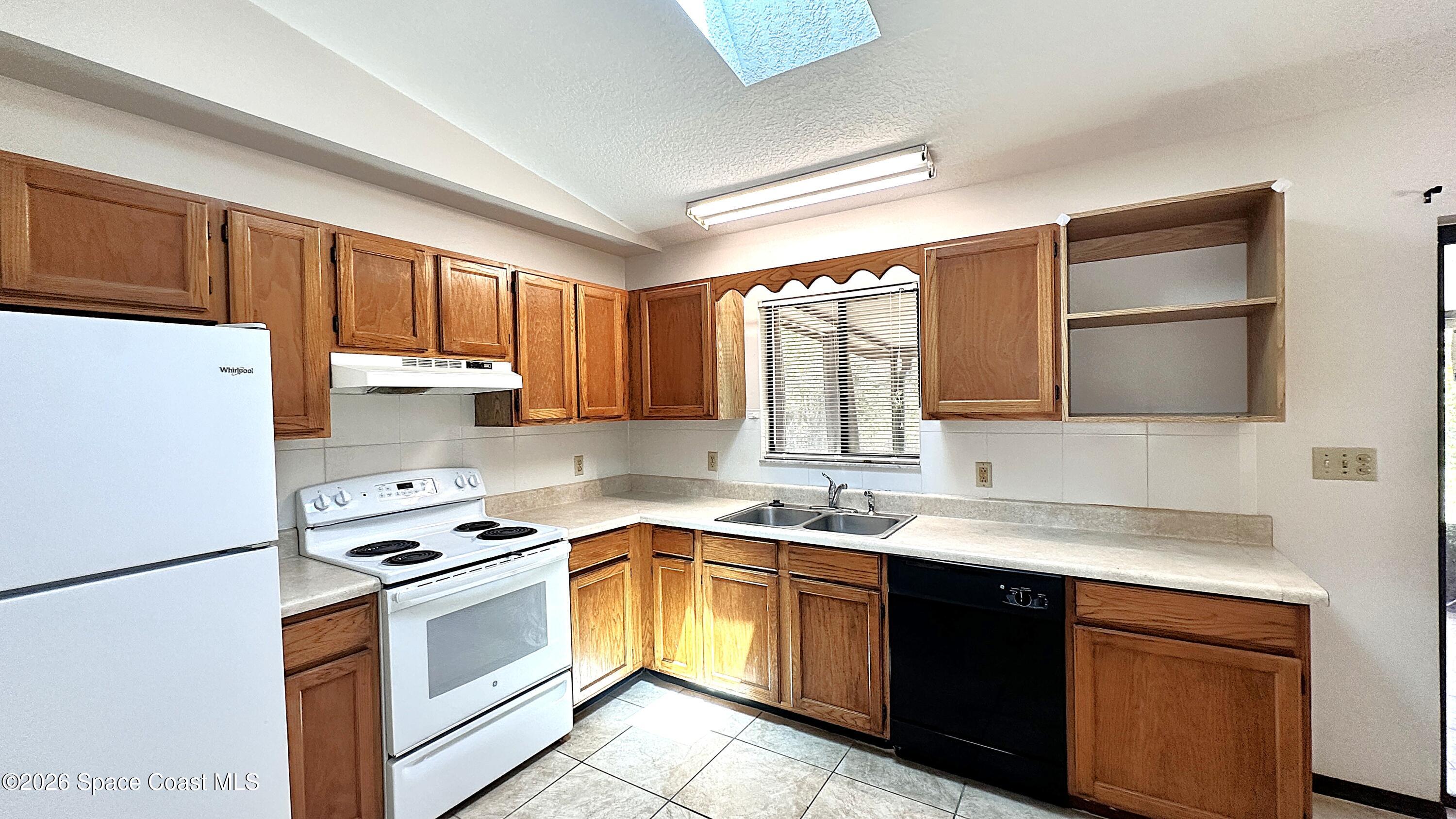 931 Commerce Road Southeast Palm Bay, FL 32909 - Photo 7 of 19 a kitchen with a sink stove top oven and refrigerator