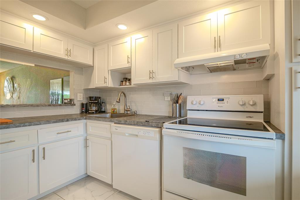 3531 Inverrary Drive, Unit 407 Lauderhill, FL 33319 - Photo 11 of 59 a kitchen with white cabinets and appliances
