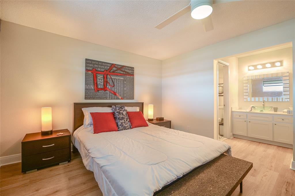 3531 Inverrary Drive, Unit 407 Lauderhill, FL 33319 - Photo 15 of 59 a bedroom with a bed and wooden floor