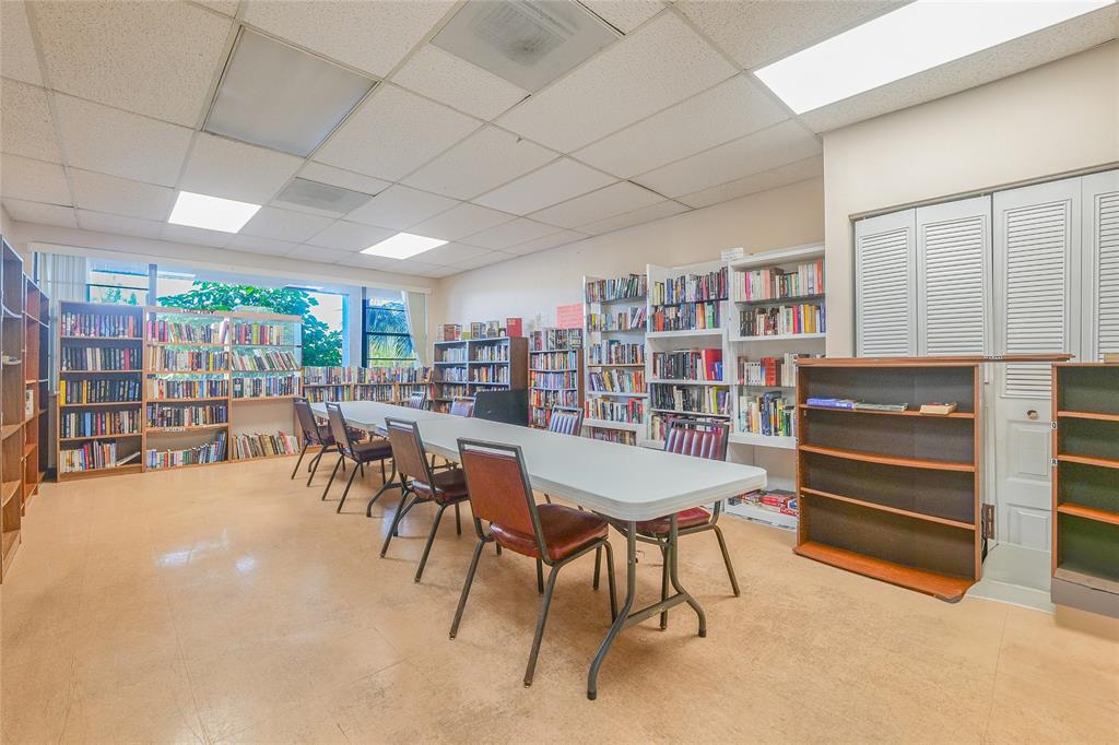 3531 Inverrary Drive, Unit 407 Lauderhill, FL 33319 - Photo 44 of 59 a dining room with furniture and a book shelf