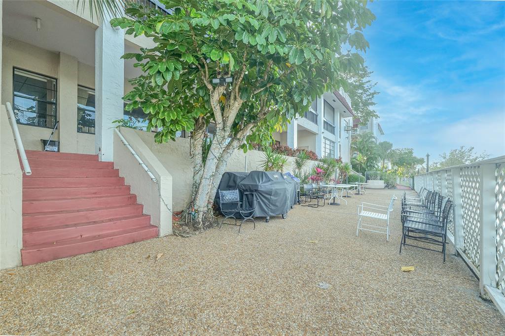 3531 Inverrary Drive, Unit 407 Lauderhill, FL 33319 - Photo 50 of 59 a view of a patio with a table and chairs