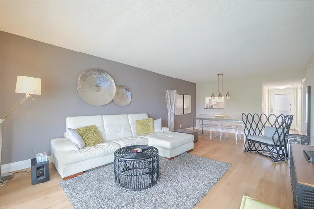 a living room with furniture a table and a potted plant