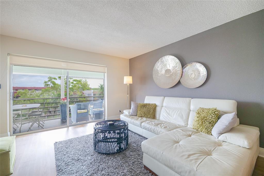 3531 Inverrary Drive, Unit 407 Lauderhill, FL 33319 - Photo 8 of 59 a living room with furniture and a large window