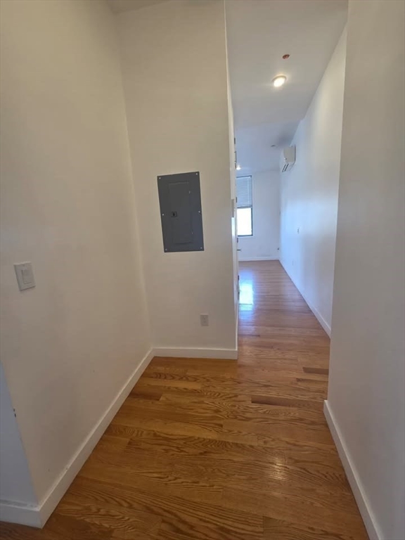 64 Market Street, Unit 303 Lynn, MA 01901 - Photo 4 of 12 a view of an empty room with wooden floor