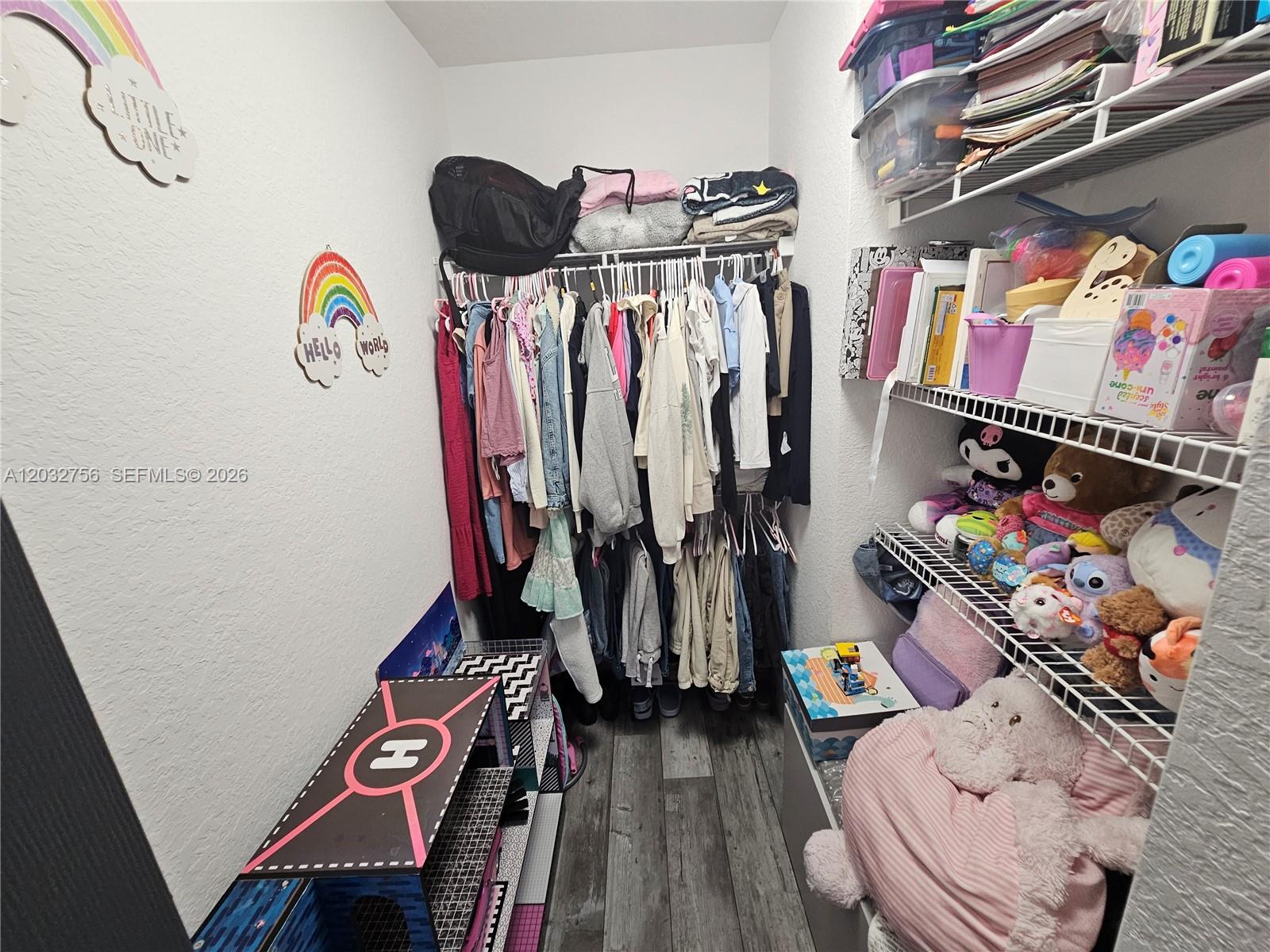4331 Southwest 124th Way Miramar, FL 33027 - Photo 19 of 40 a view of walk in closet with clothes
