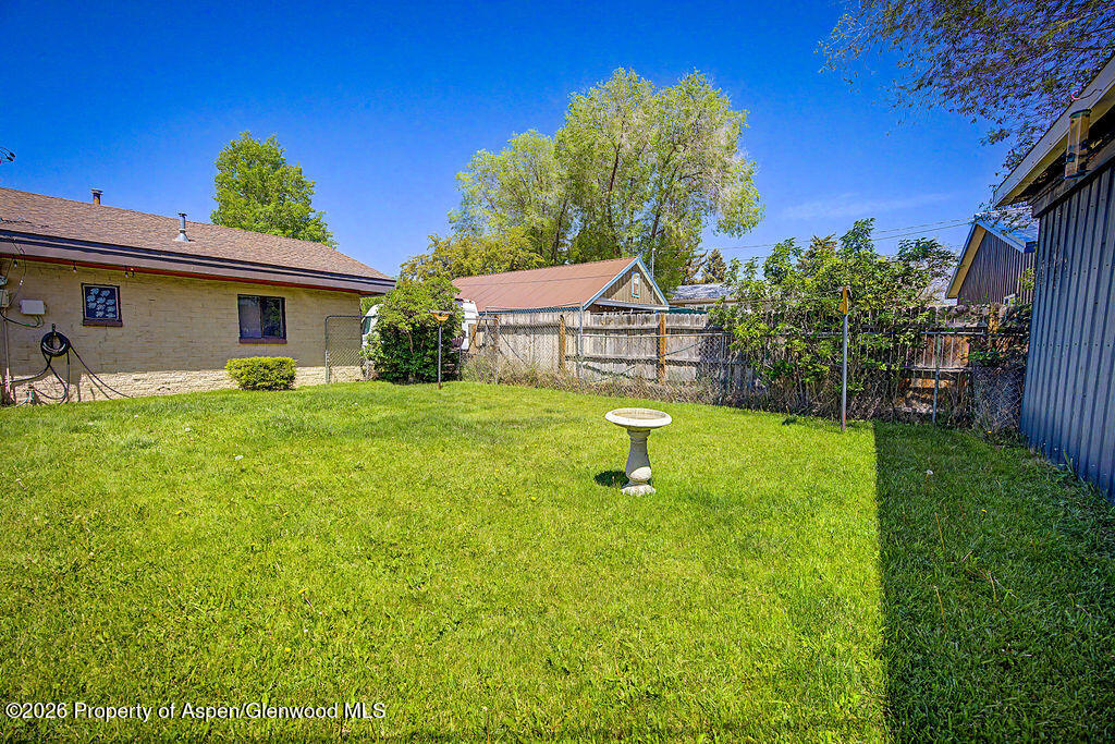 625 Russell Street Craig, CO 81625 - Photo 10 of 35 a view of a house with a backyard