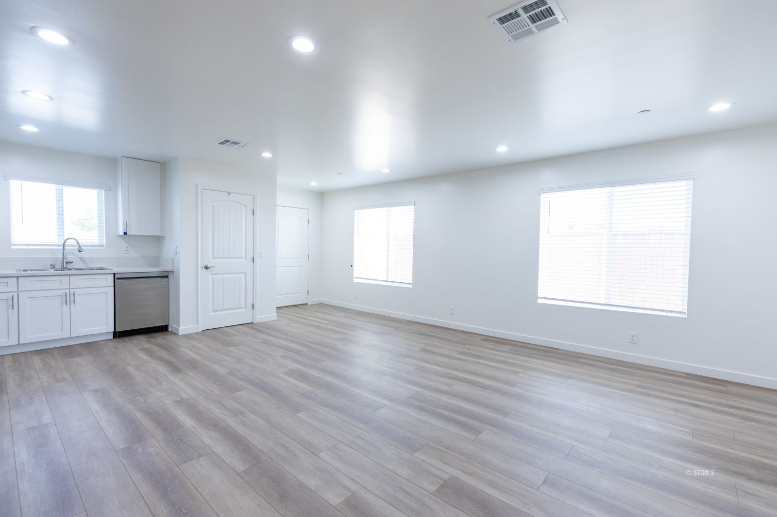 713 South Downs Street Ridgecrest, CA 93555 - Photo 23 of 38 an empty room with wooden floor and windows