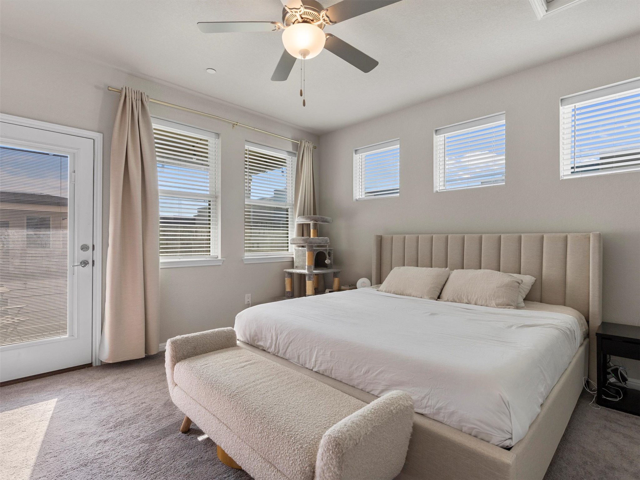 9015 Cattle Baron Path, Unit 2001 Austin, TX 78747 - Photo 14 of 32 a bedroom with a large bed and a chandelier