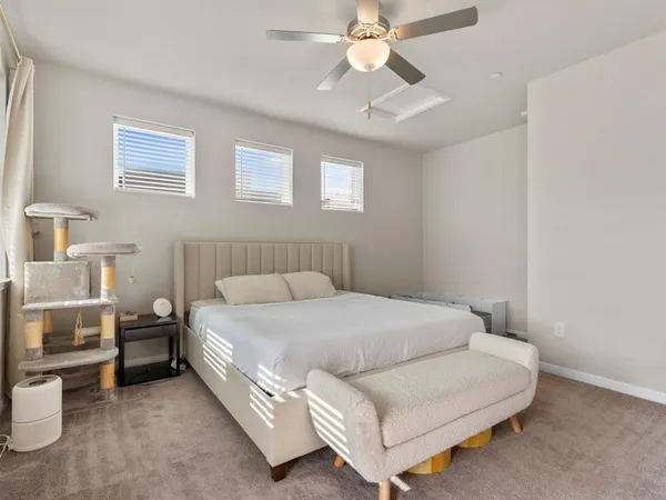 a bedroom with a large bed and a chandelier