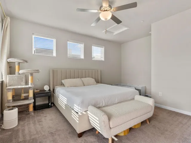 a bedroom with a large bed and a chandelier