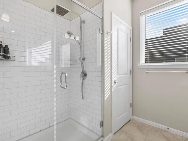 a bathroom with double sink and a shower