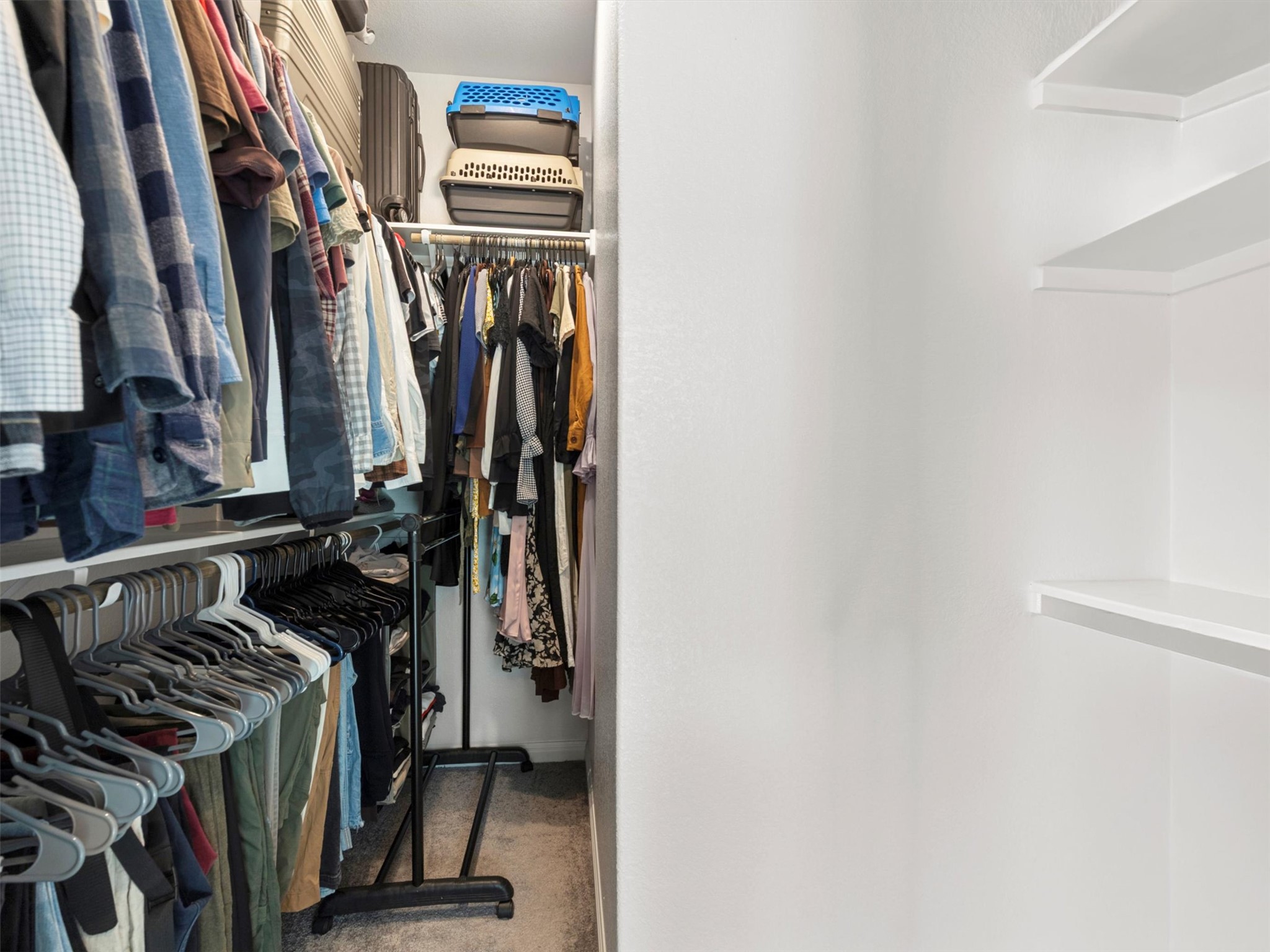 9015 Cattle Baron Path, Unit 2001 Austin, TX 78747 - Photo 18 of 32 a view of walk in closet with clothes and shoes