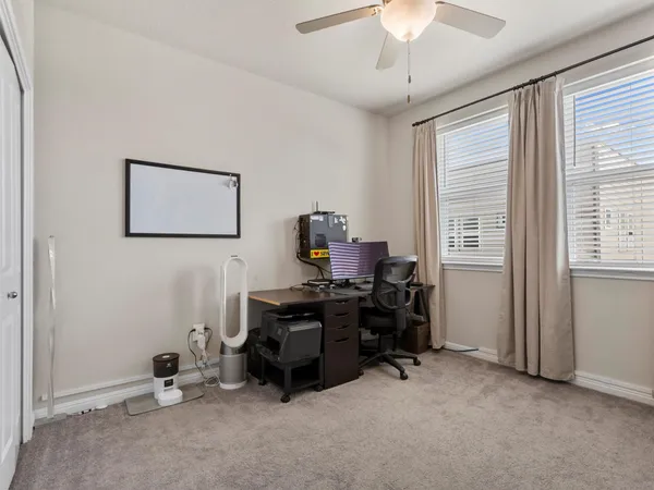 a living room with furniture and a glass door shower