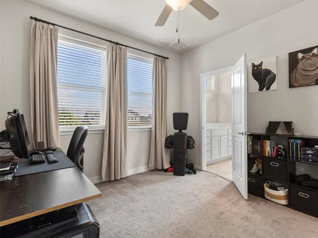 a view of a workspace with furniture and a window