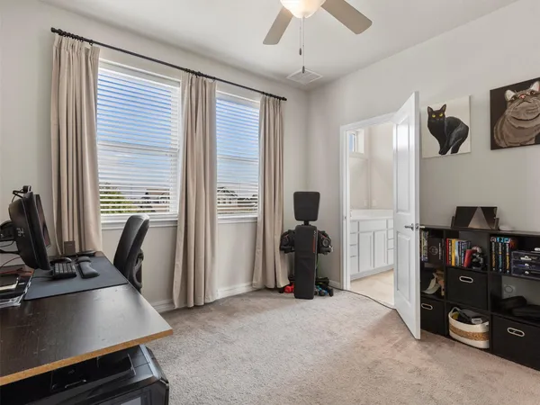 a view of a workspace with furniture and a window