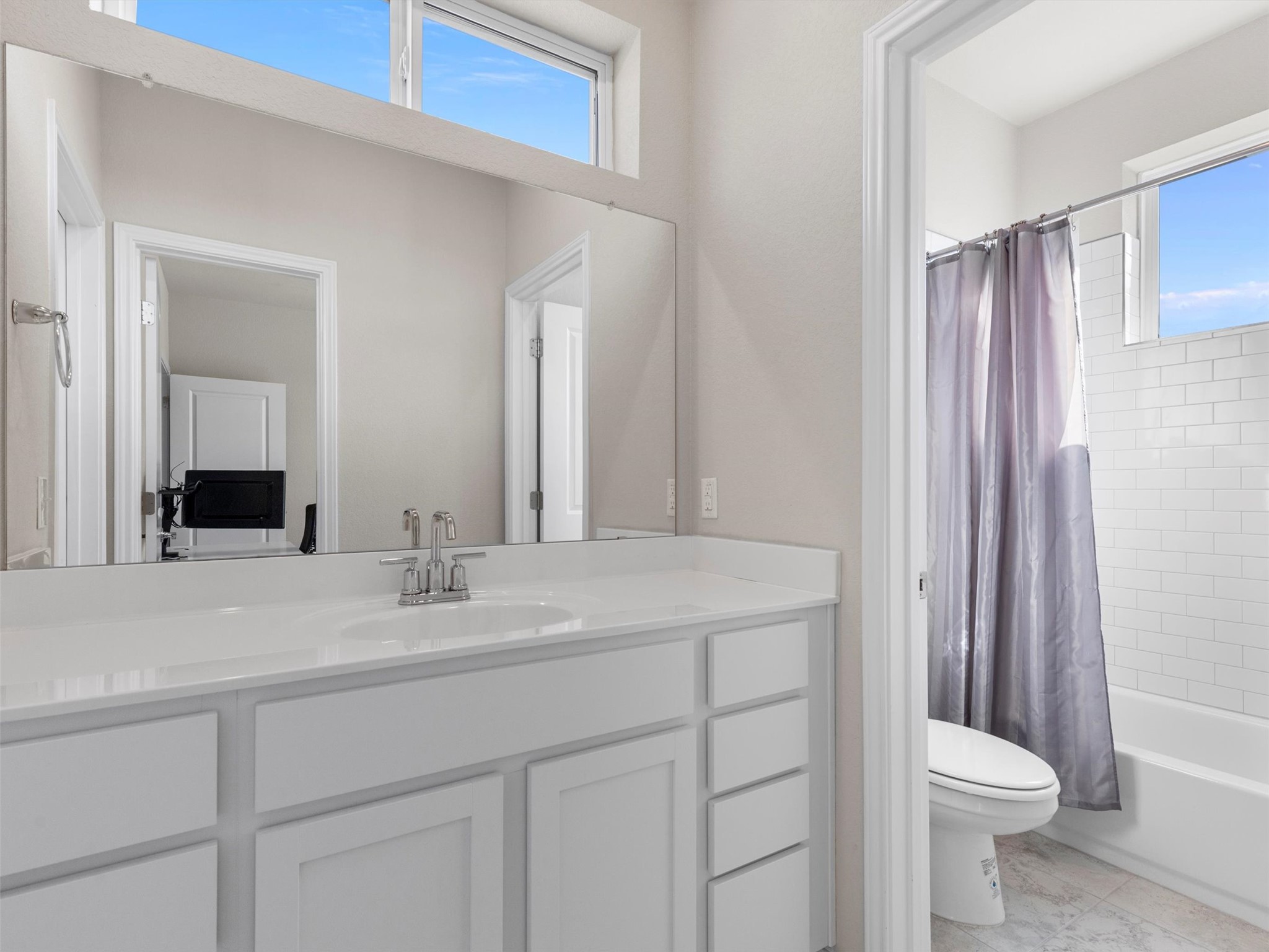 9015 Cattle Baron Path, Unit 2001 Austin, TX 78747 - Photo 23 of 32 a bathroom with a sink a toilet and shower