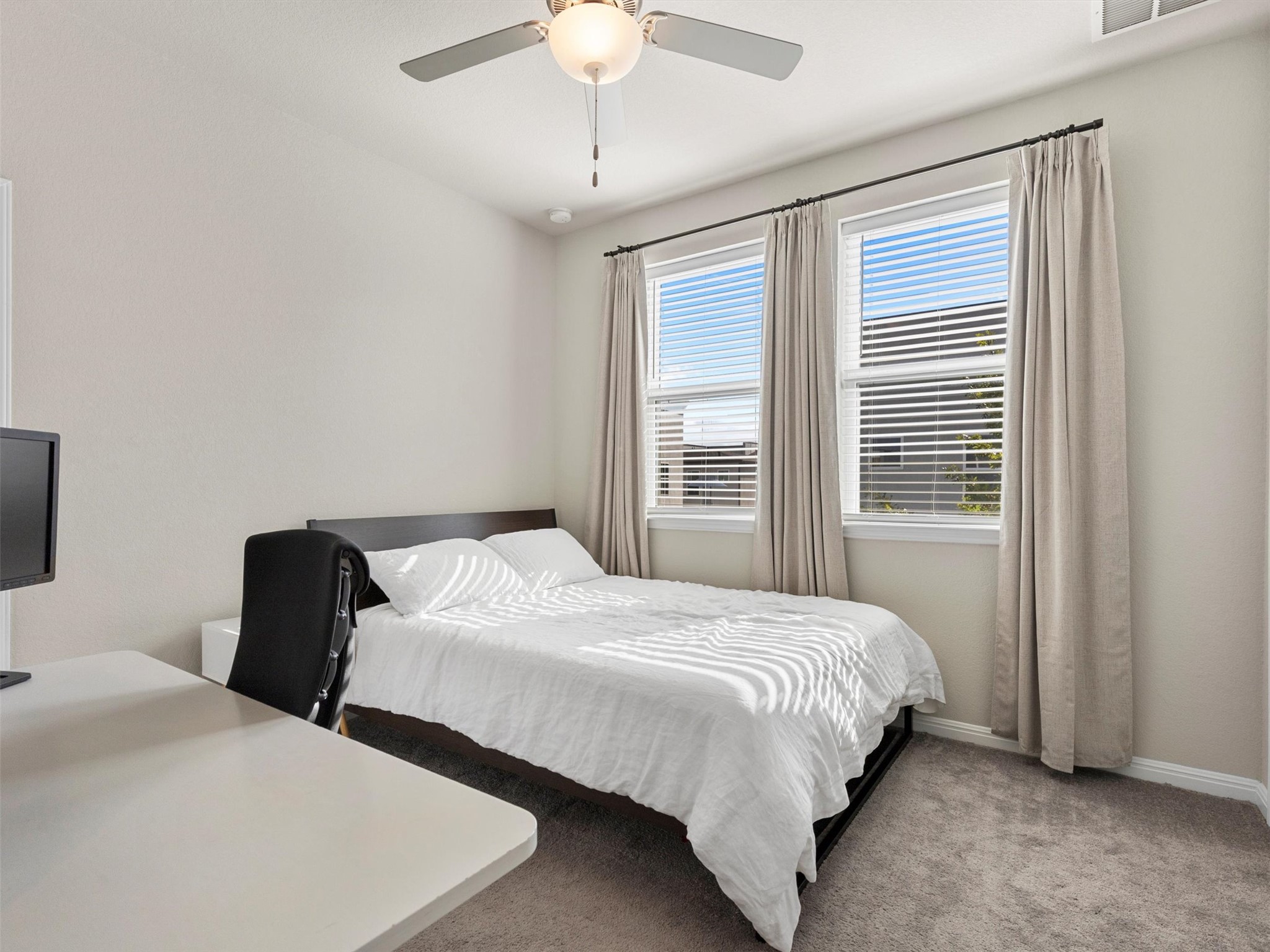 9015 Cattle Baron Path, Unit 2001 Austin, TX 78747 - Photo 24 of 32 a bedroom with two beds and a chandelier
