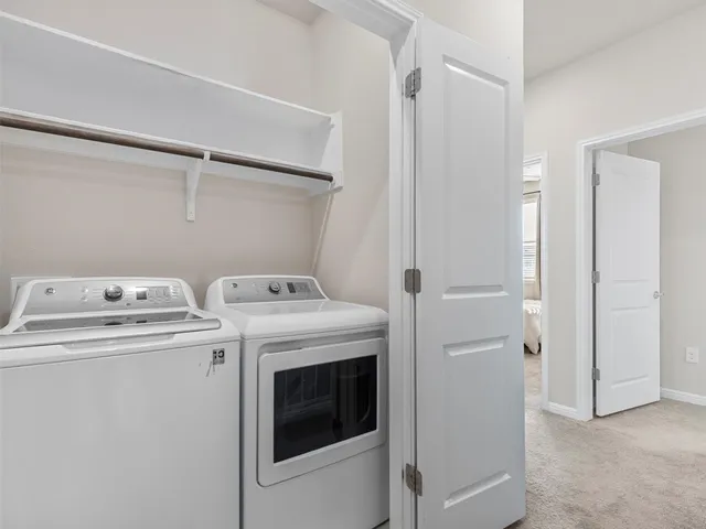 a bedroom with two beds and a chandelier