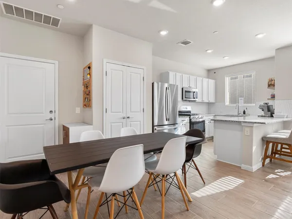 a large kitchen with kitchen island a sink table and chairs