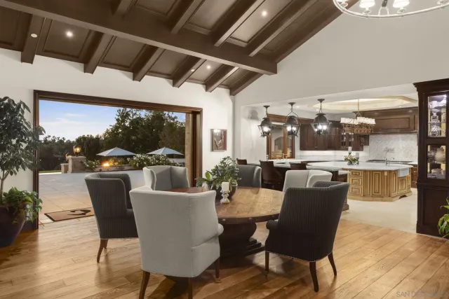 a kitchen with a table chairs stove and granite counter tops