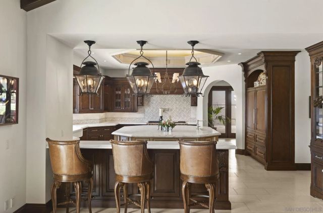 a living room with patio furniture and a fireplace