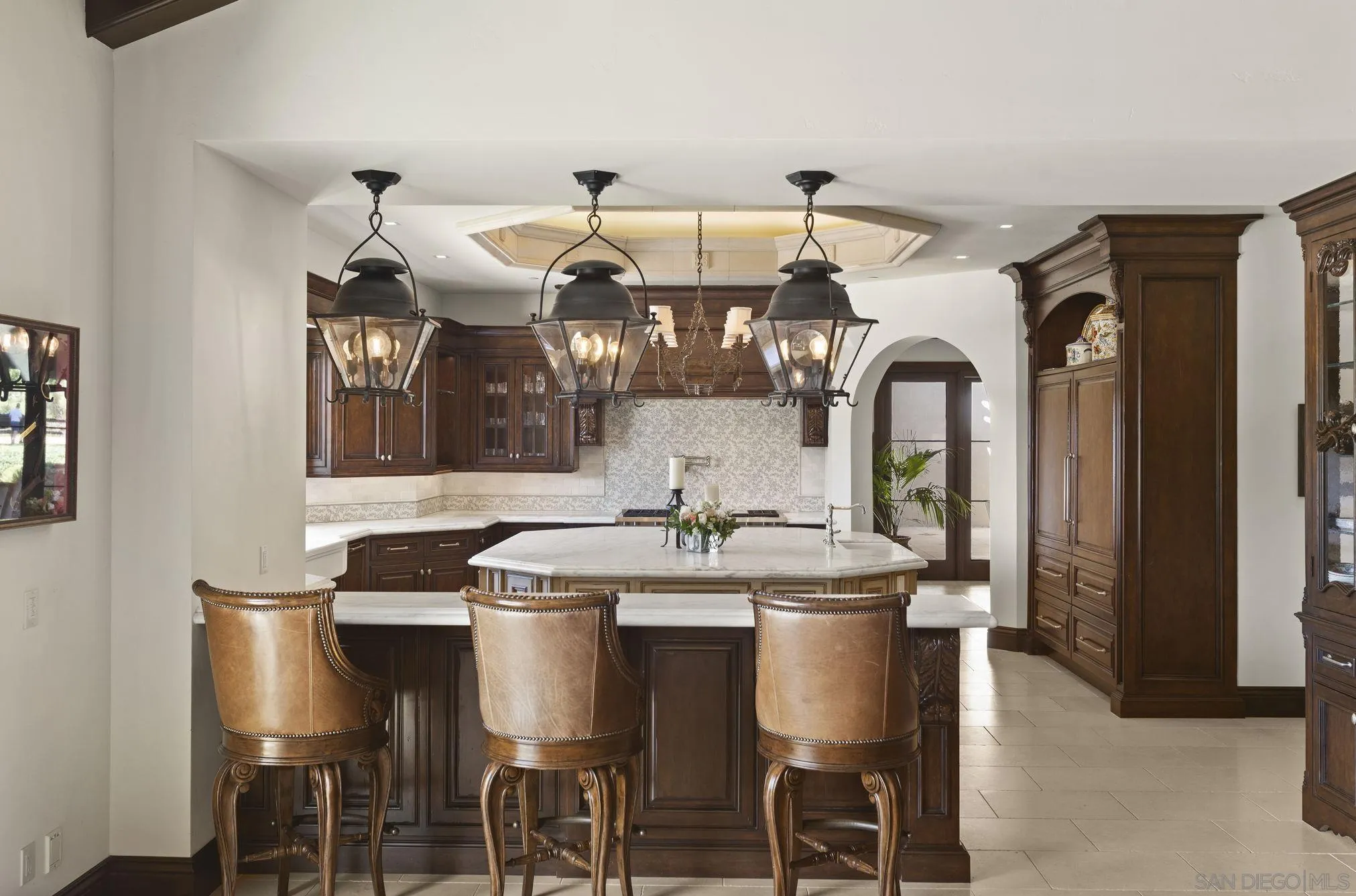 17872 Via De Fortuna Rancho Santa Fe, CA 92067 - Photo 18 of 53 a kitchen with a dining table and chairs