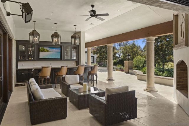 a view of a swimming pool with lawn chairs under an umbrella