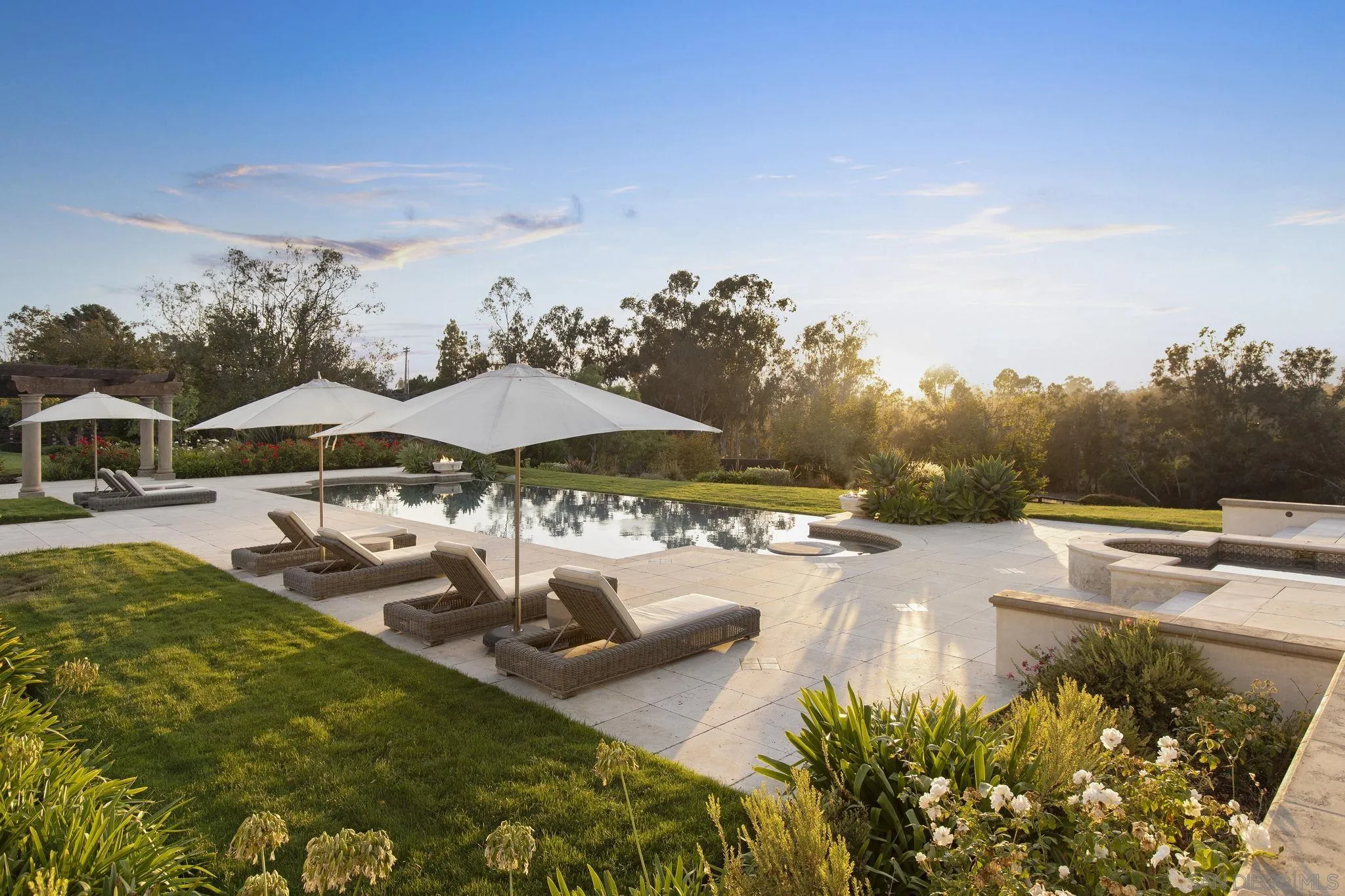 17872 Via De Fortuna Rancho Santa Fe, CA 92067 - Photo 20 of 53 a view of a swimming pool with lawn chairs under an umbrella