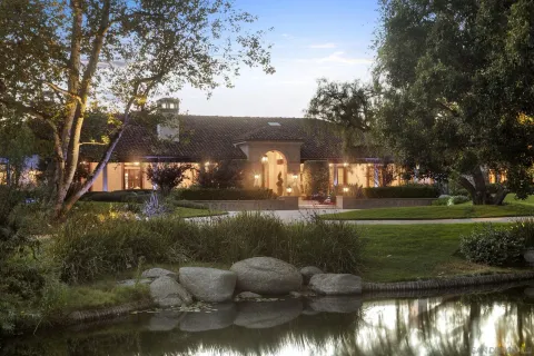 a view of a lake with a house in the background