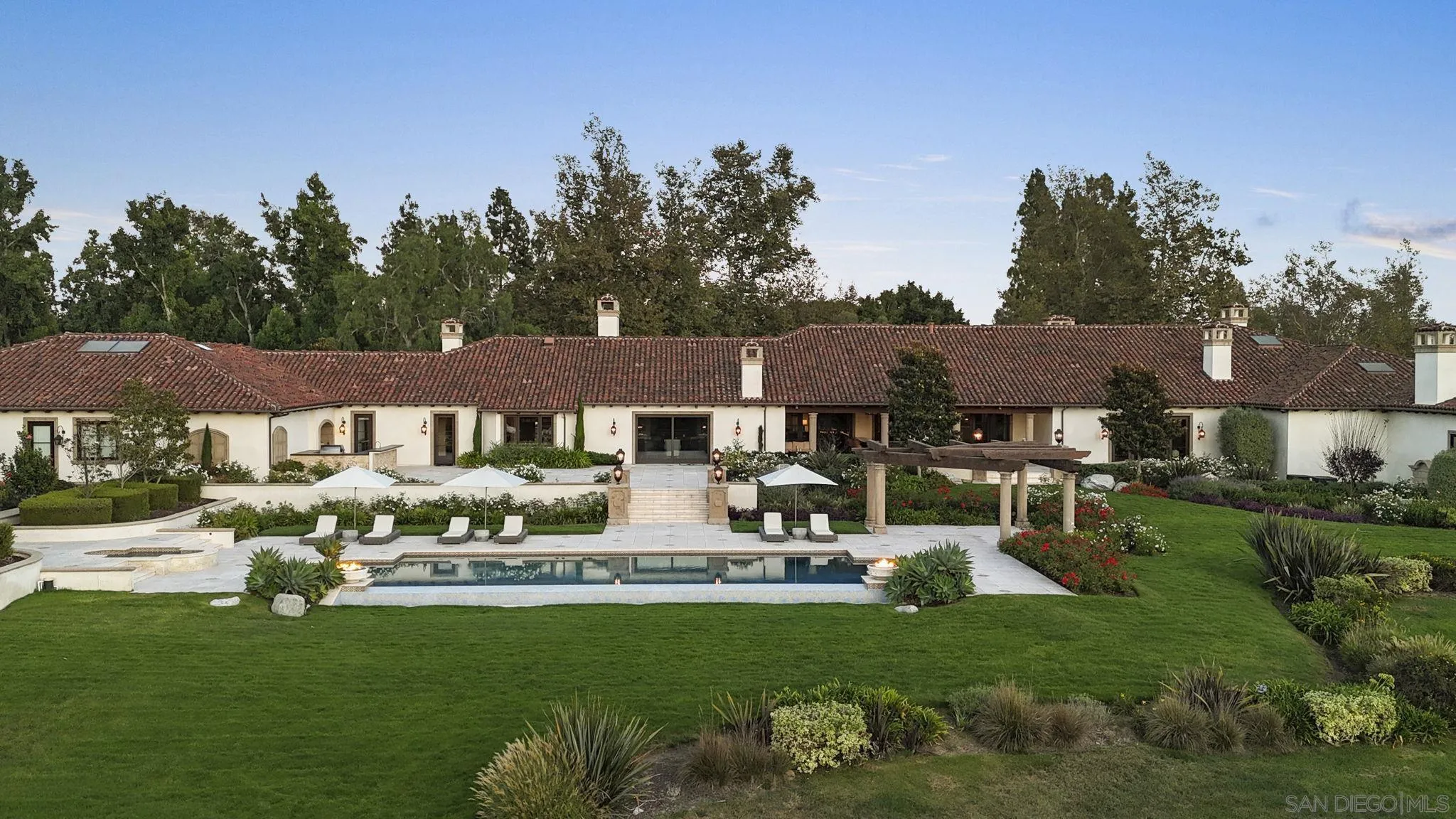 17872 Via De Fortuna Rancho Santa Fe, CA 92067 - Photo 21 of 53 a front view of a house with a garden and trees