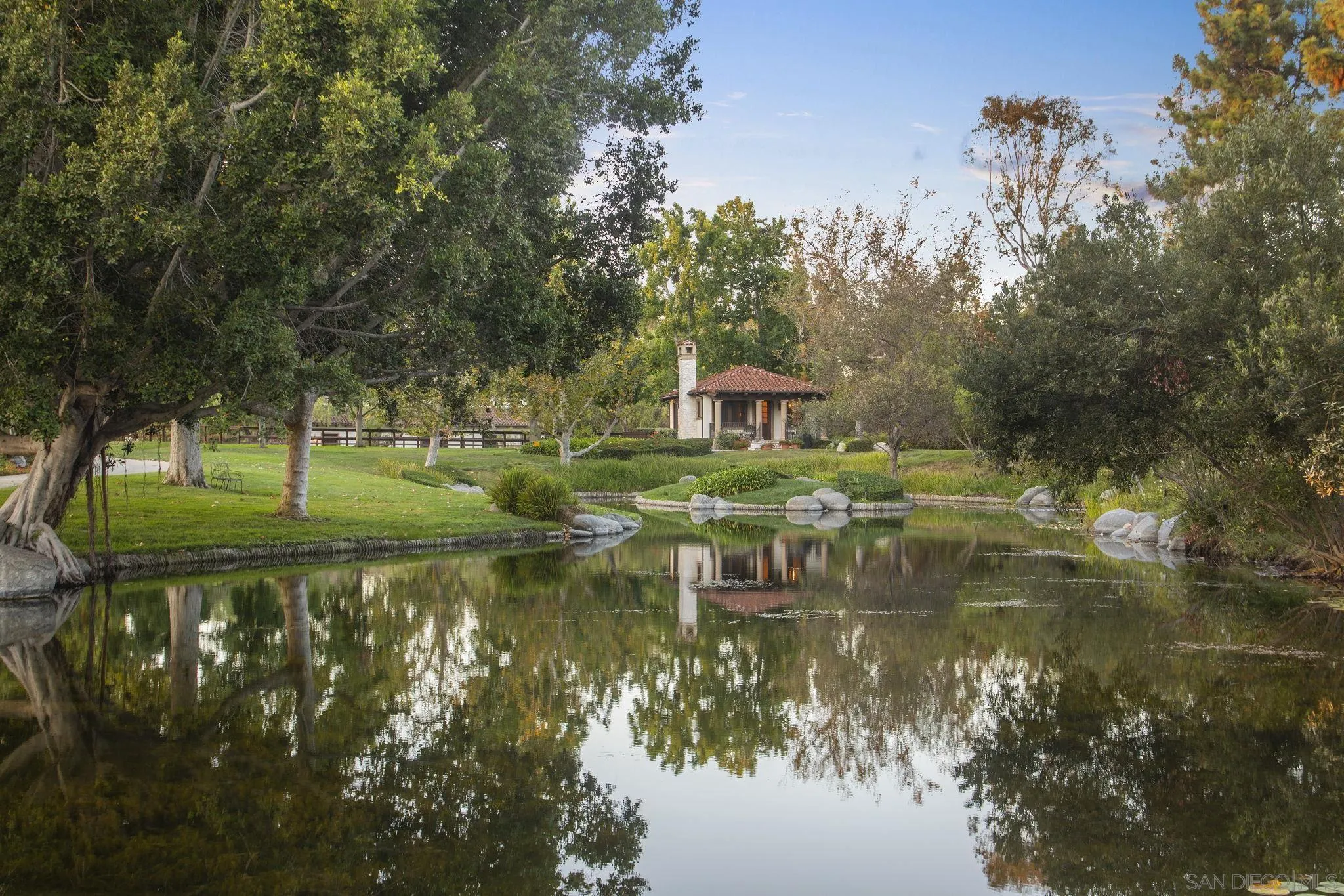 17872 Via De Fortuna Rancho Santa Fe, CA 92067 - Photo 3 of 53 a view of a lake with a house in the background