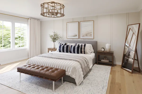 a bedroom with a bed and a large mirror