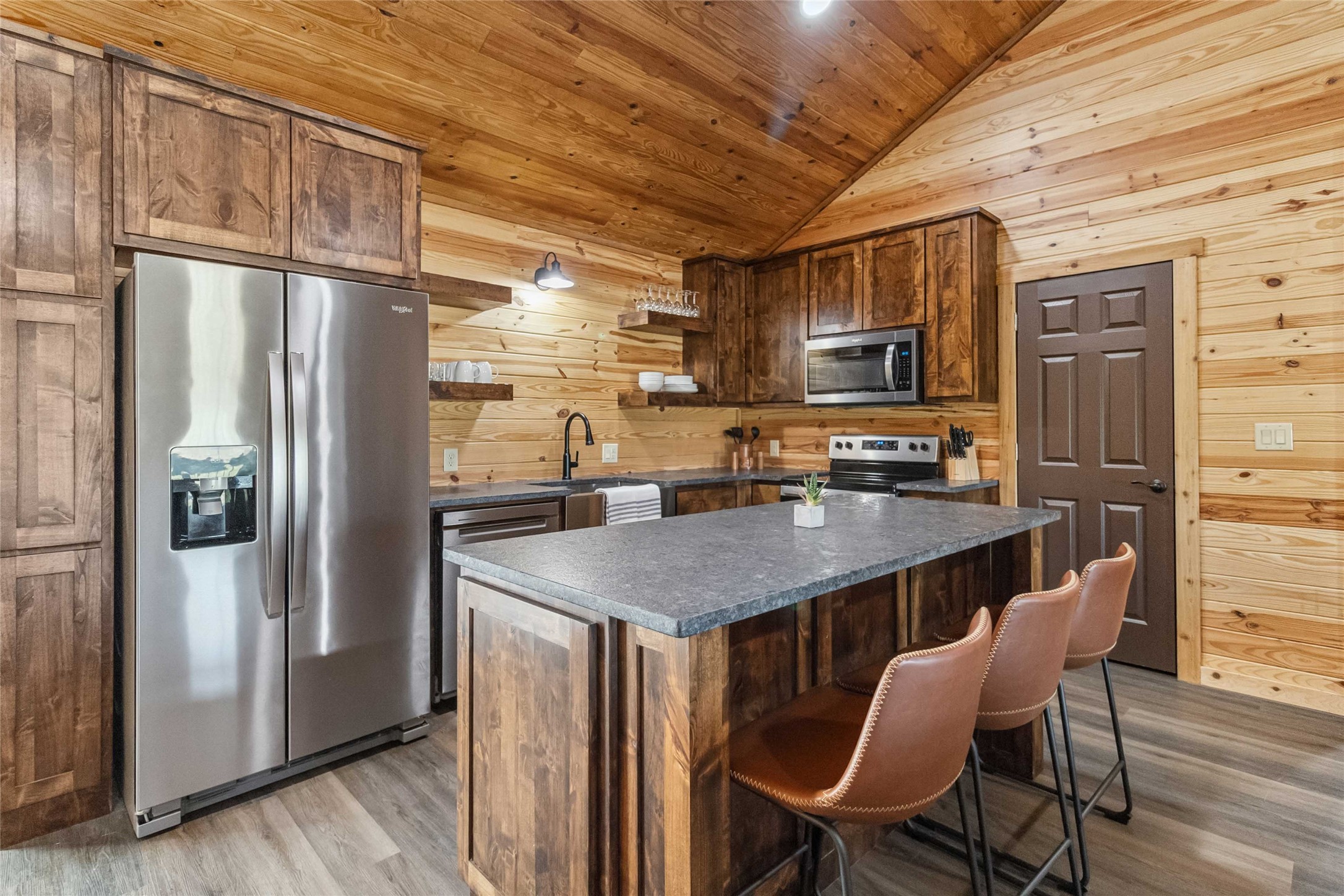 1591 Scull Road San Marcos, TX 78666 - Photo 8 of 26 Kitchen with a sink, stainless steel appliances, wooden walls, wooden ceiling, and vaulted ceiling